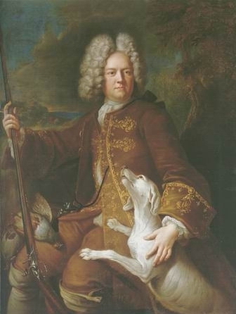 huntman with a rifle and dog